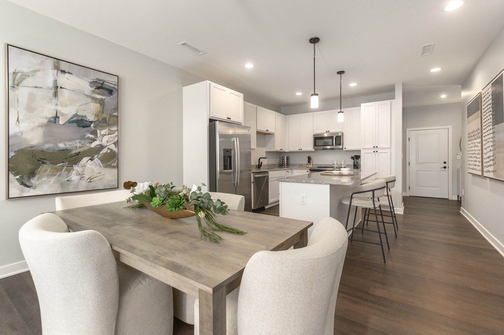 a kitchen and dining room with a table and chairs